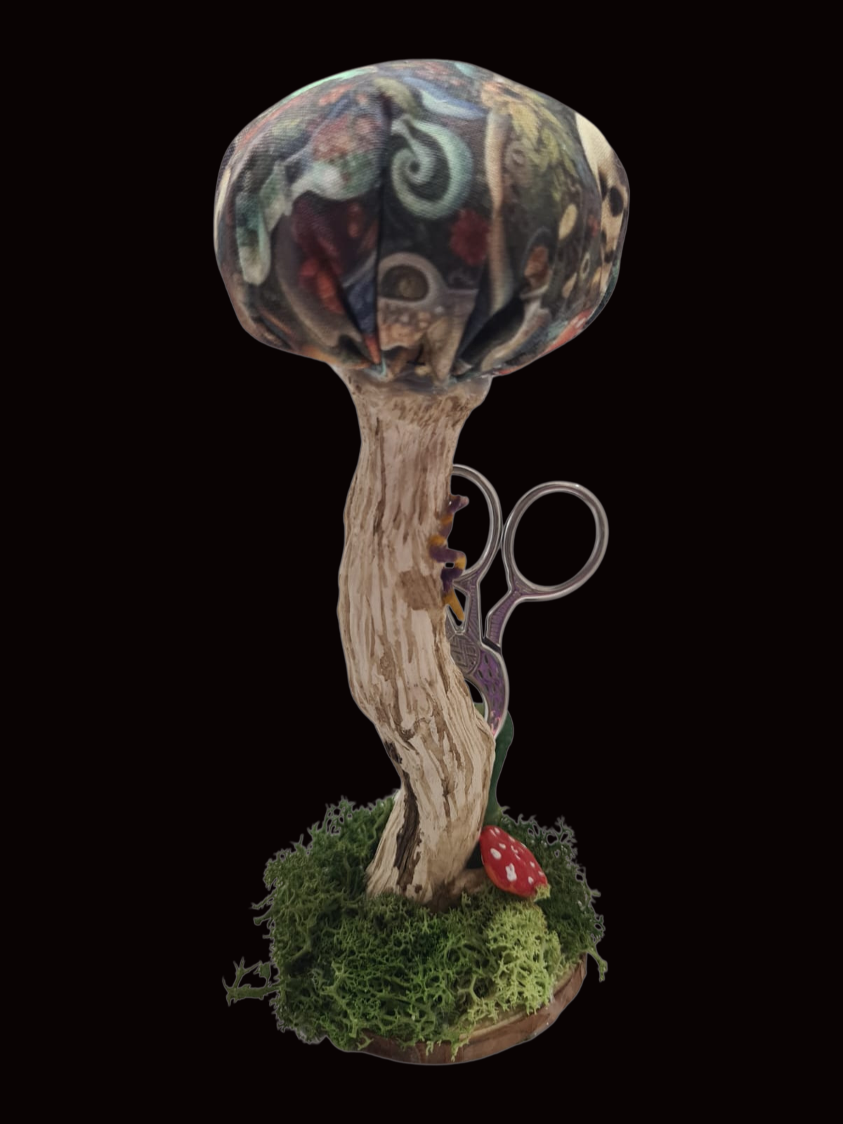 Handmade shroom pin cushion in Potion Keeper dragon fabric with small sewing scissors.