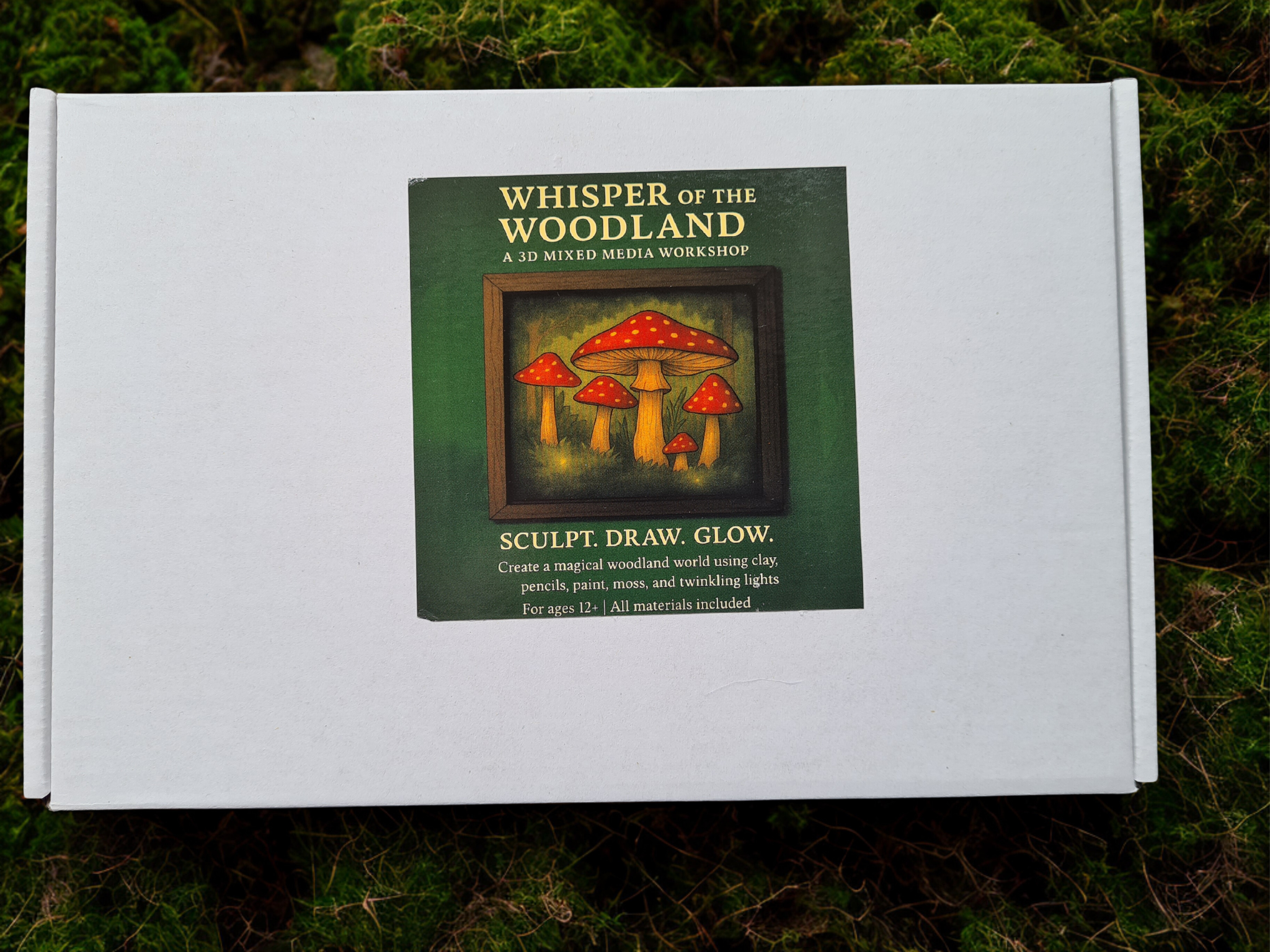 Box packaging for “Whisper of The Woodland” 3D mixed media art kit, showing sculpting materials, moss, fairy lights, and gothic branding for an enchanted forest craft experience.